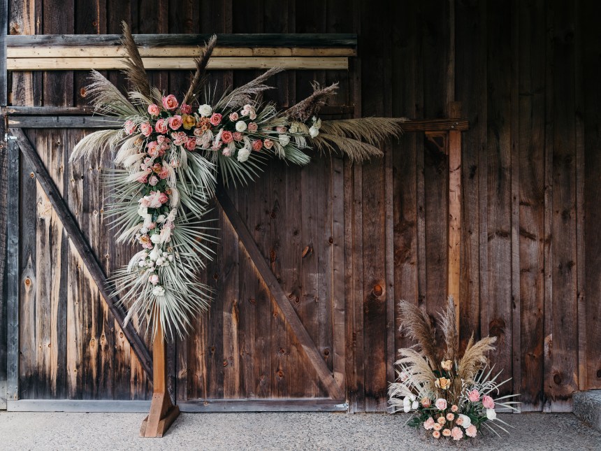 Floral arbor with dried materials for barn wedding