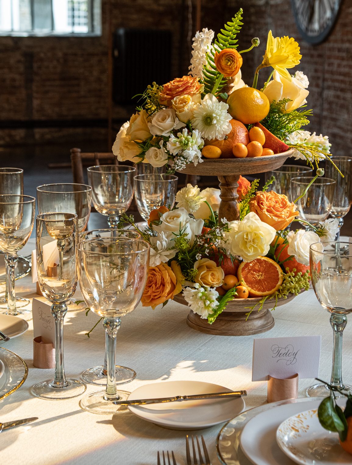 Wedding floral centerpiece with citrus fruits by Boston and Burke Floral Design