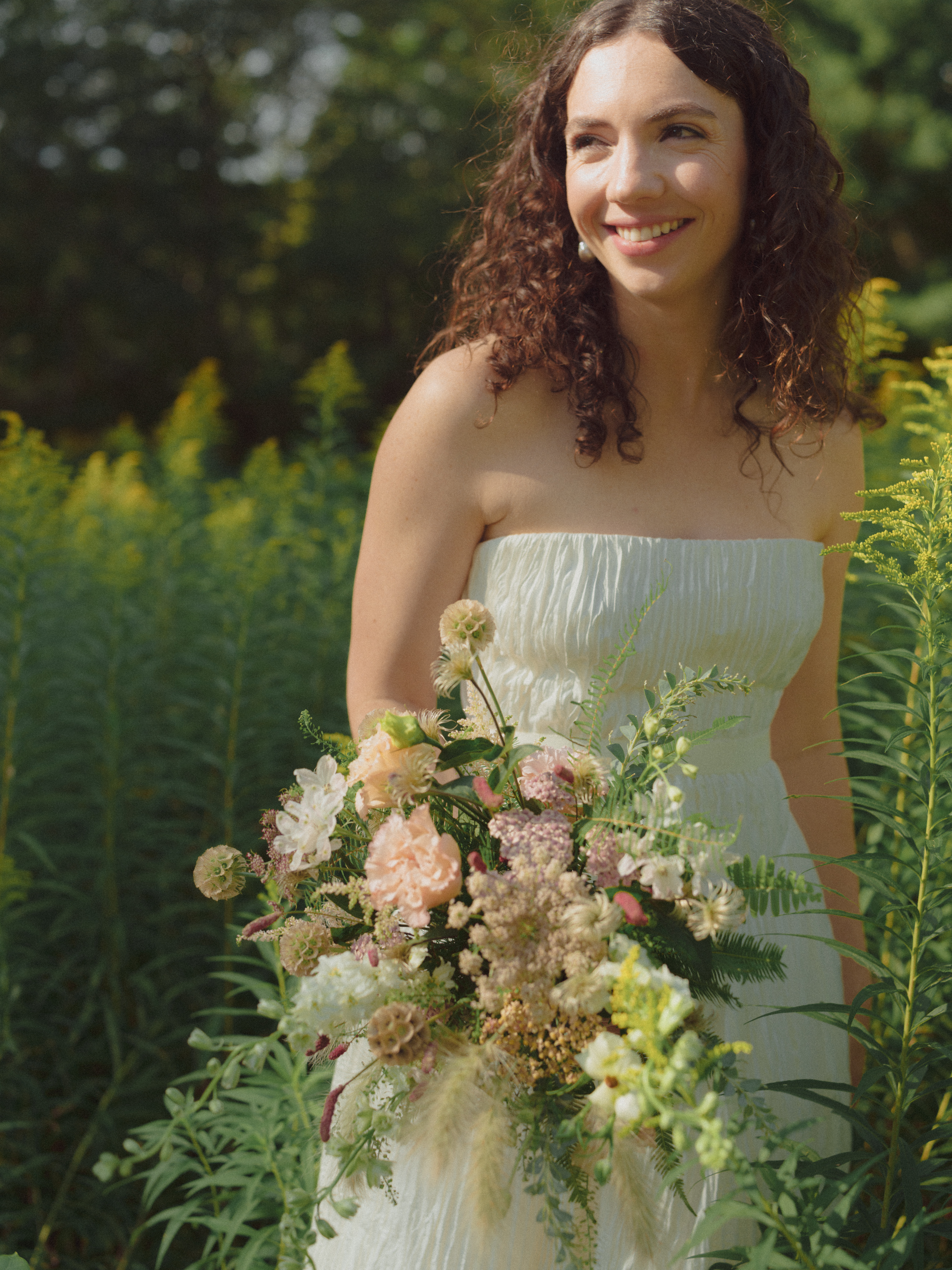 Bride holding woodland inspired wedding bouquet