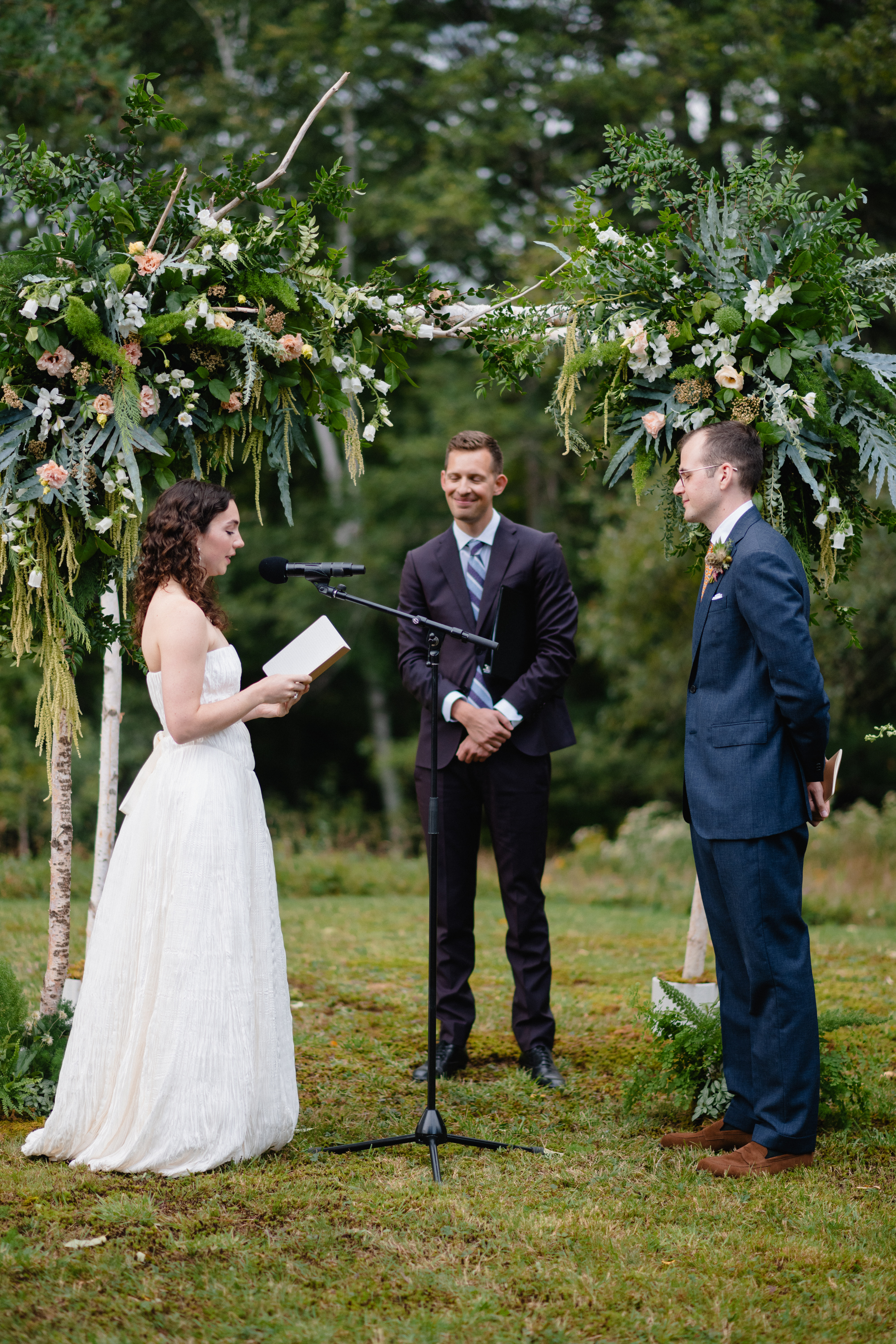 Wedding ceremony under birch chuppah with woodland inspired floral installations