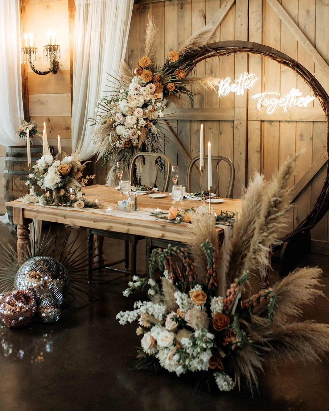 Sweetheart table with abundant florals in boho neutral palette.