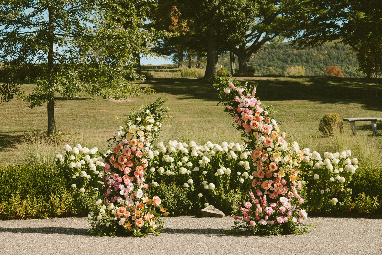 Floral wedding ceremony open arch with a sunset palette at The Sablewood in Schoharie.
