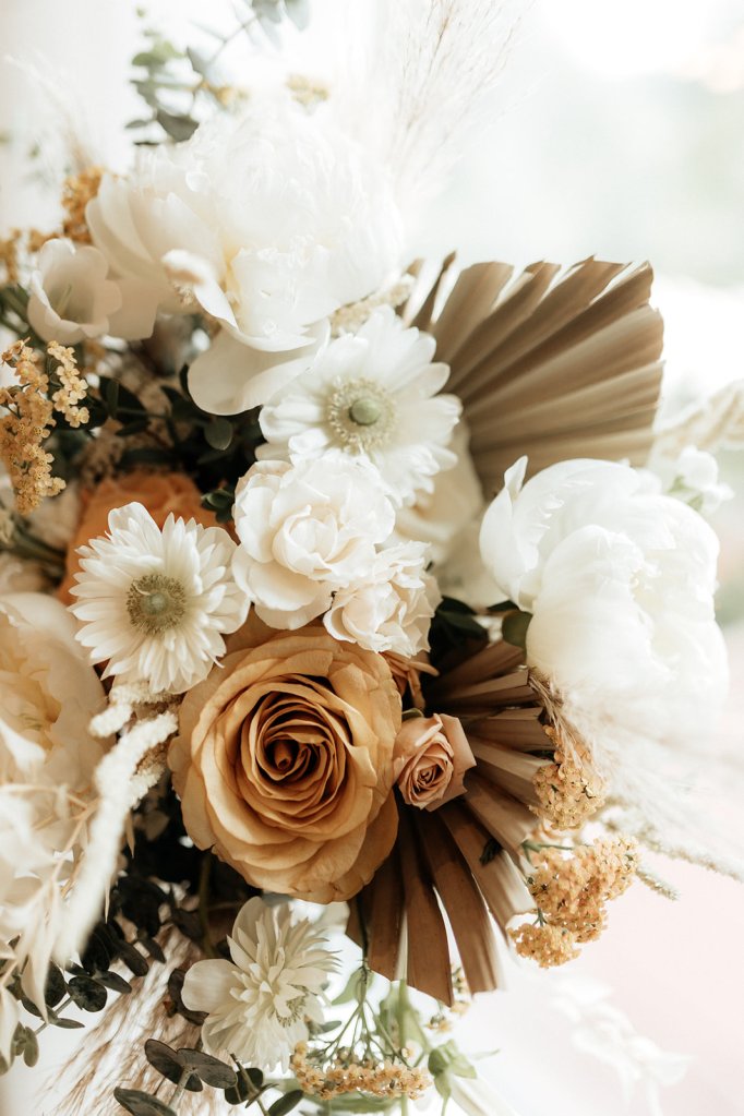 Wedding bouquet in neutral palette with fresh flowers and dried botanicals.