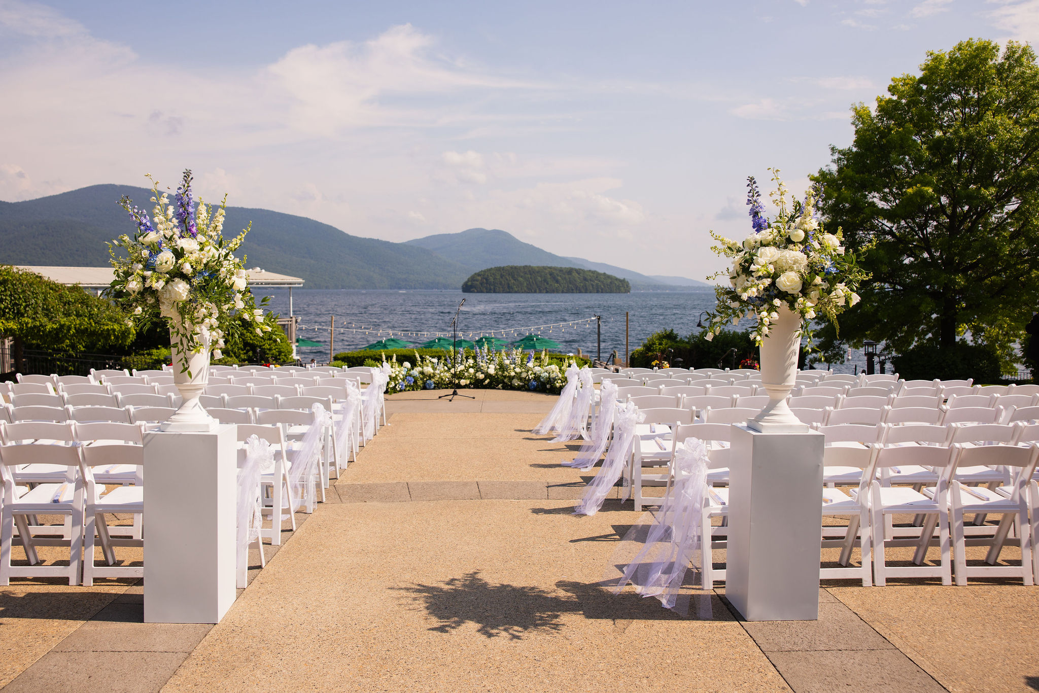 Wedding ceremony site at The Sagamore Resort showing outdoor aisle with floral arrangements.